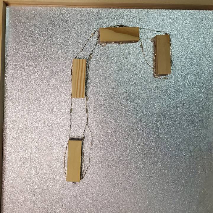 Lights off wrapped around blocks for candy cane light up Christmas box