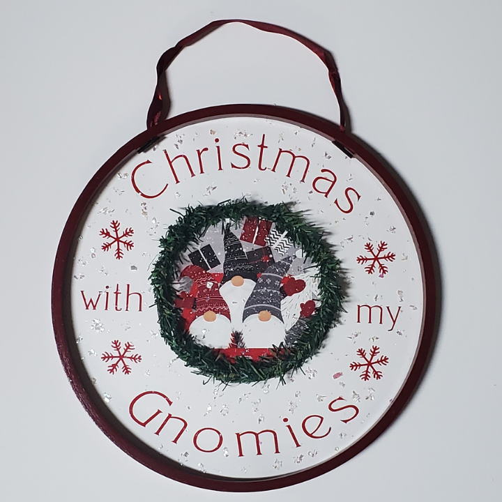 Round, red Circle wall hanging with Christmas with my gnomies on the inside with a small wreath with gnomes inside.