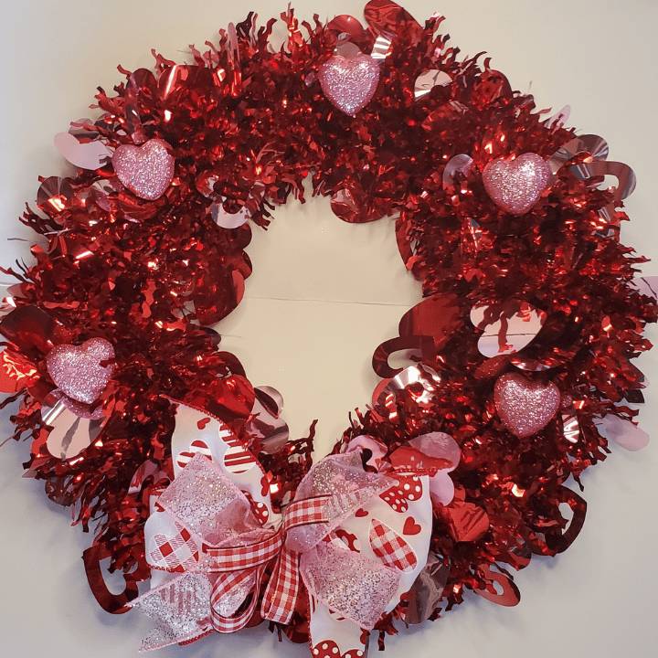 twinethyme finished valentines wreath diy red, pink garland wreath with pink glitter foam hearts and three ribbon bow.